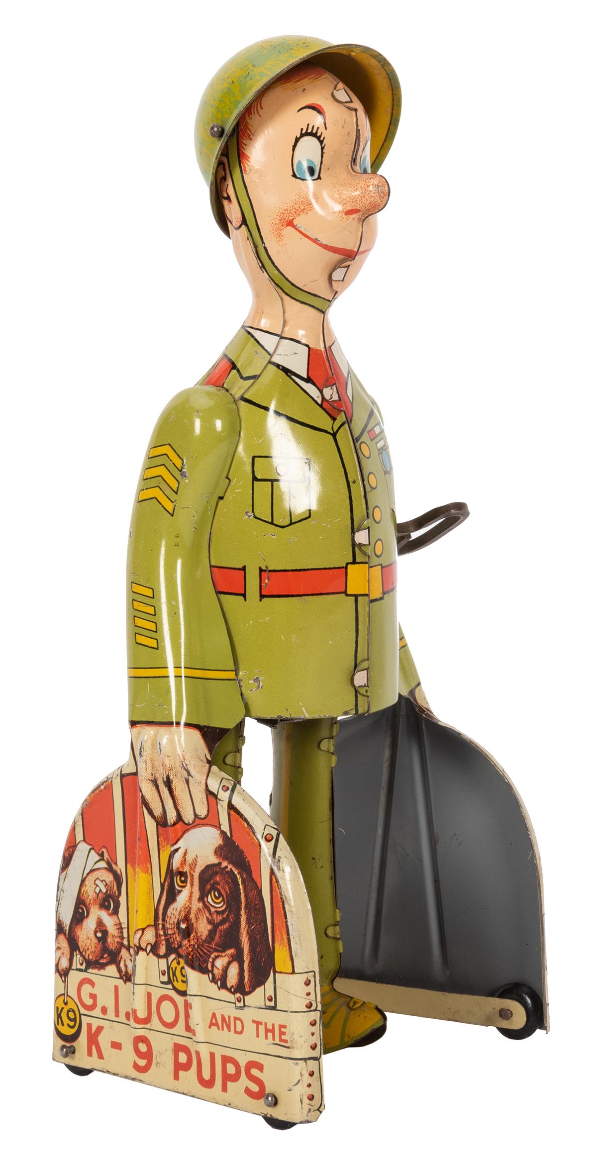 Unique Art G.I. Joe and the K—9 Pups Wind-Up Toy.: Unique Art G.I. Joe and the K—9 Pups Wind-Up Toy. Lithographed tin walking figure with original helmet on swivel. Height 9”. Working mechanism.