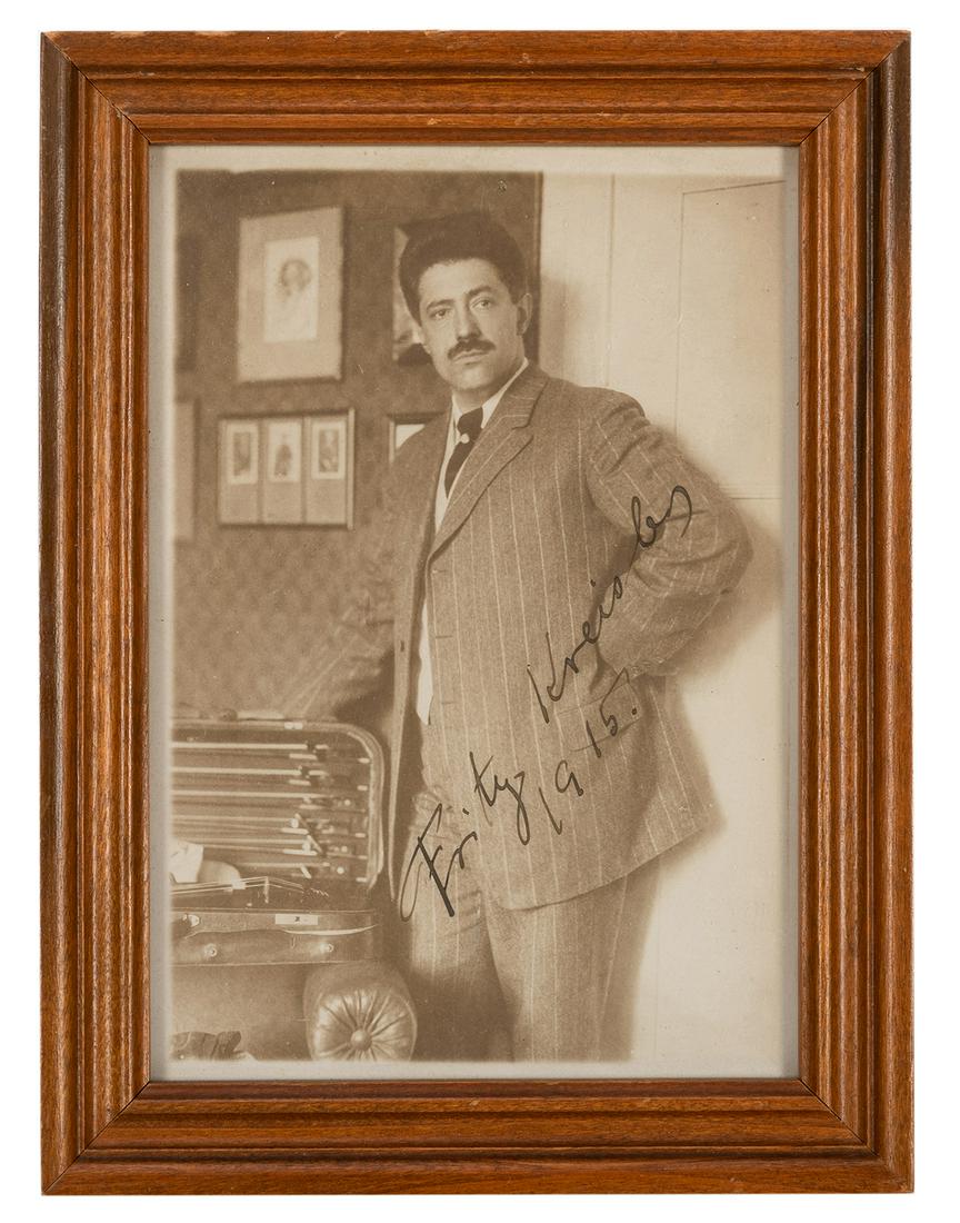 Fritz Kreisler Signed Photo.: Kreisler, Fritz. Fritz Kreisler Signed Photo. Dated 1915. A matte-finish photo of Kreisler with an open violin case to his side signed in fountain pen “Frits Kreisler/1915.” Framed, sight 