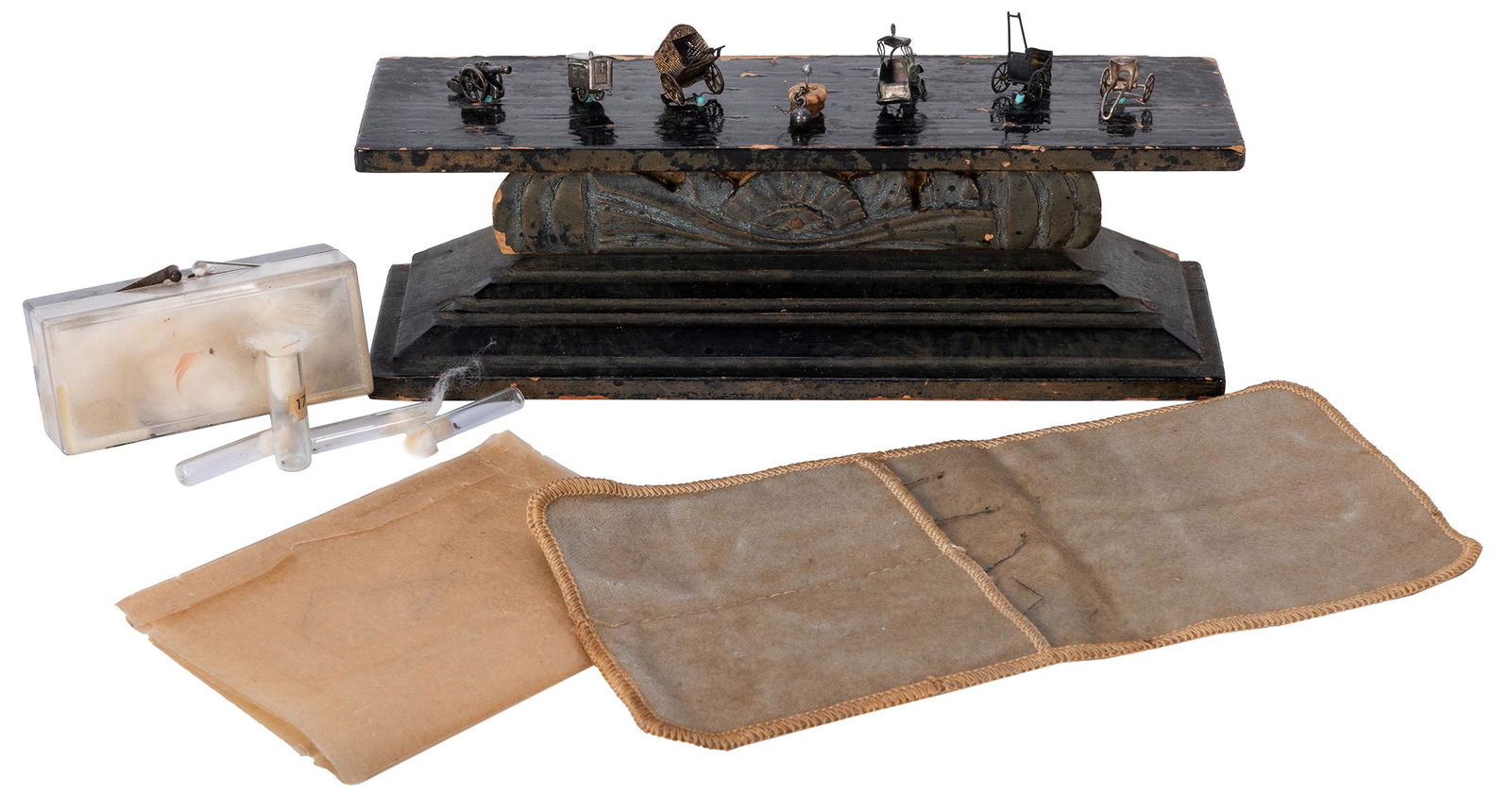 Flea Circus.: Flea Circus. American, ca. 1930s. An authentic vintage sideshow flea circus act, comprised of a wooden platform to which seven miniature metal carts, carriages, a cannon, and ball and chain are affixe