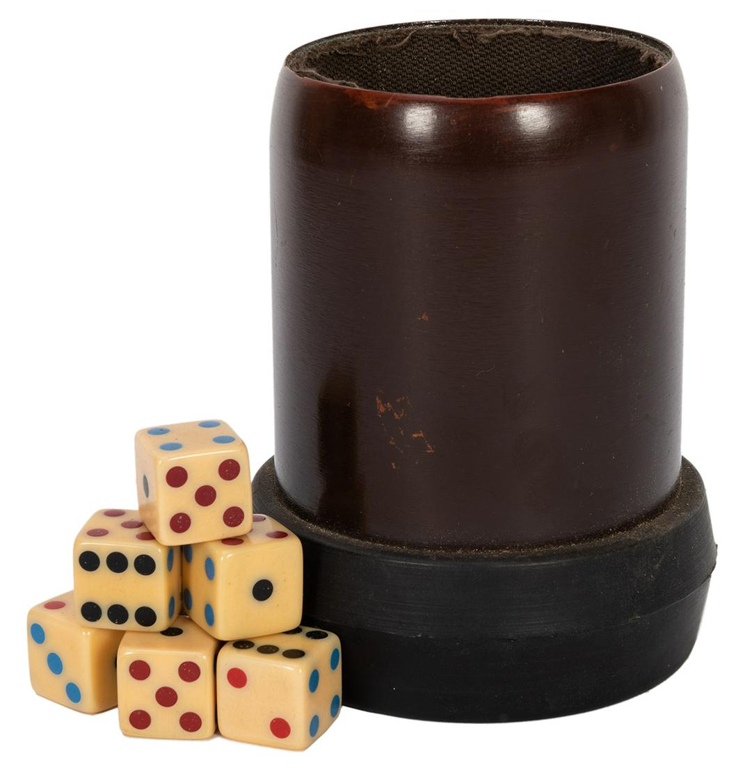 Whip Cup and Dice.: Whip Cup and Dice. American, ca. 1980. Dice cup lined with fabric that allows the operator to control the roll of special dice. Includes seven shaved whip dice. Some wear to interior fabric, otherwise