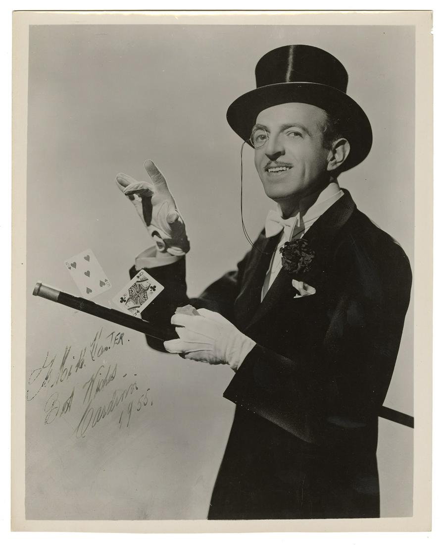 Cardini Portrait, Inscribed and Signed.: Cardini (Richard Valentine Pitchford). Cardini Portrait, Inscribed and Signed. Circa 1950. Iconic ¾ length image of the master manipulator, two cards balanced on the walking stick held in one gloved 