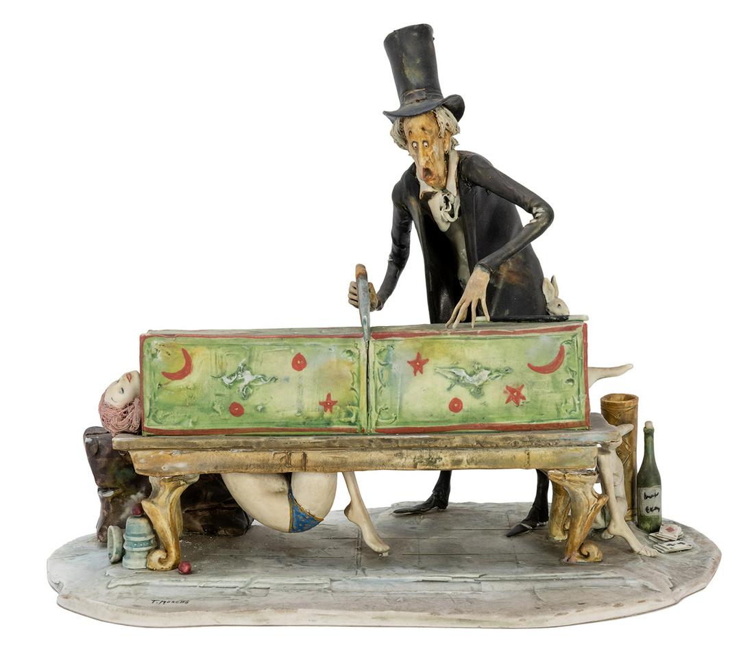 Moretto, Toni (Italian 1929-2011). Sawing in Half: Moretto, Toni (Italian, 1929-2011). Sawing in Half Illusion Sculpture. Italy: Lo Scriccolo, ca. 1990s. Fired clay sculpture depicting a magician sawing a woman in half – though his method of con