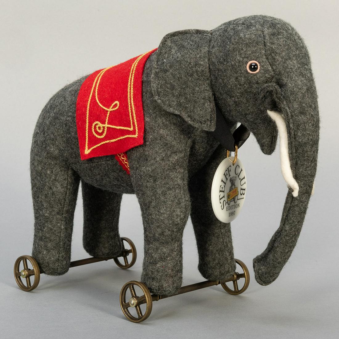 Steiff Club Elephant on Wheels. 1997. Limited edition.: Steiff Club Elephant on Wheels. 1997. Limited edition. EAN 420115. Height 8 ½”. Steiff Club button, white tag.
