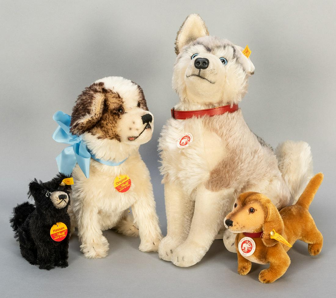 Lot of 4 Steiff Dogs. Including Ernesto (2005; EAN: Lot of 4 Steiff Dogs. Including Ernesto (2005; EAN 079702), 14”; St. Bernard (EAN 401367), 10 ½”; Bazi (035081), 5 ½”; and Hassan (078767), 6”.