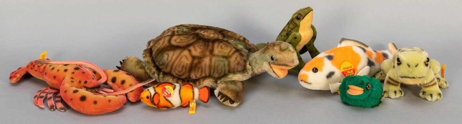 Steiff Aquatic / Amphibian Figures Group. Vintage and: Steiff Aquatic / Amphibian Figures Group. Vintage and modern Steiff animals, including Crabby lobster (035555), 11”; Carp (121838), 12”; Froggy (092060), 4”; Pom Pom Frog (vintage; 7