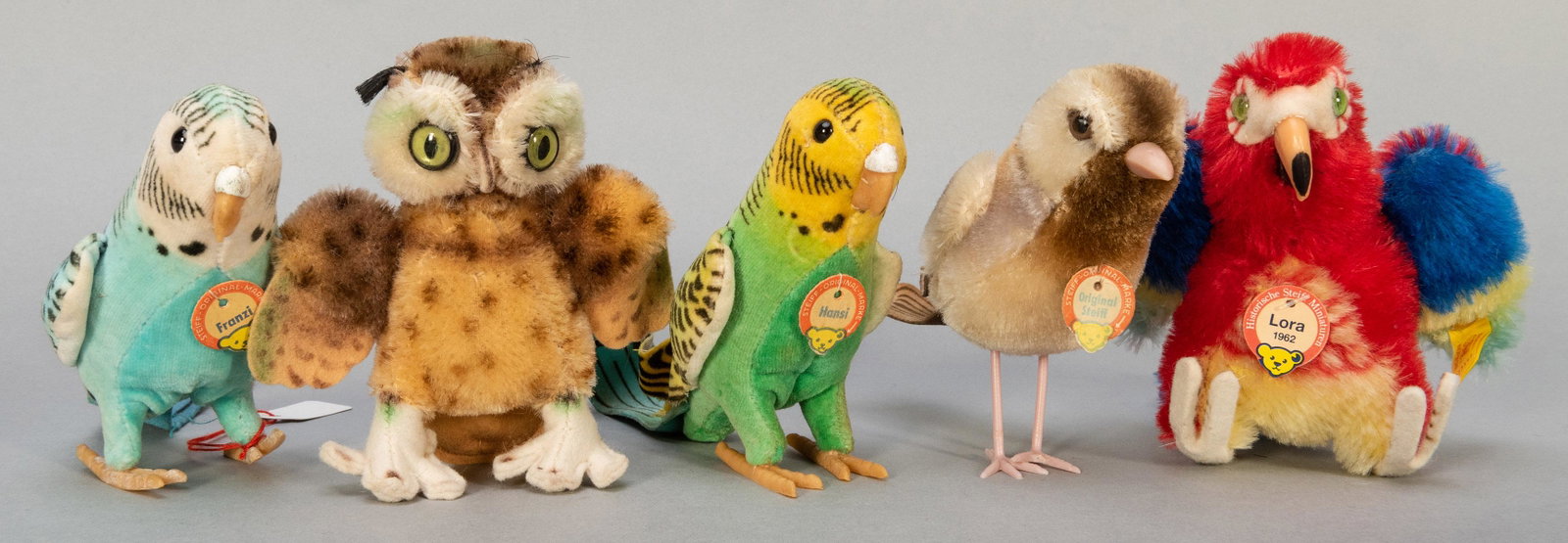 Steiff Birds and Parrots Group. Five pieces, including: Steiff Birds and Parrots Group. Five pieces, including vintage Hansi, Franzi, Wittie, and Sparrow; and Lora 1962 Replica. Height of each approx. 4”. All but Wittie retain name tags, and Sparrow 