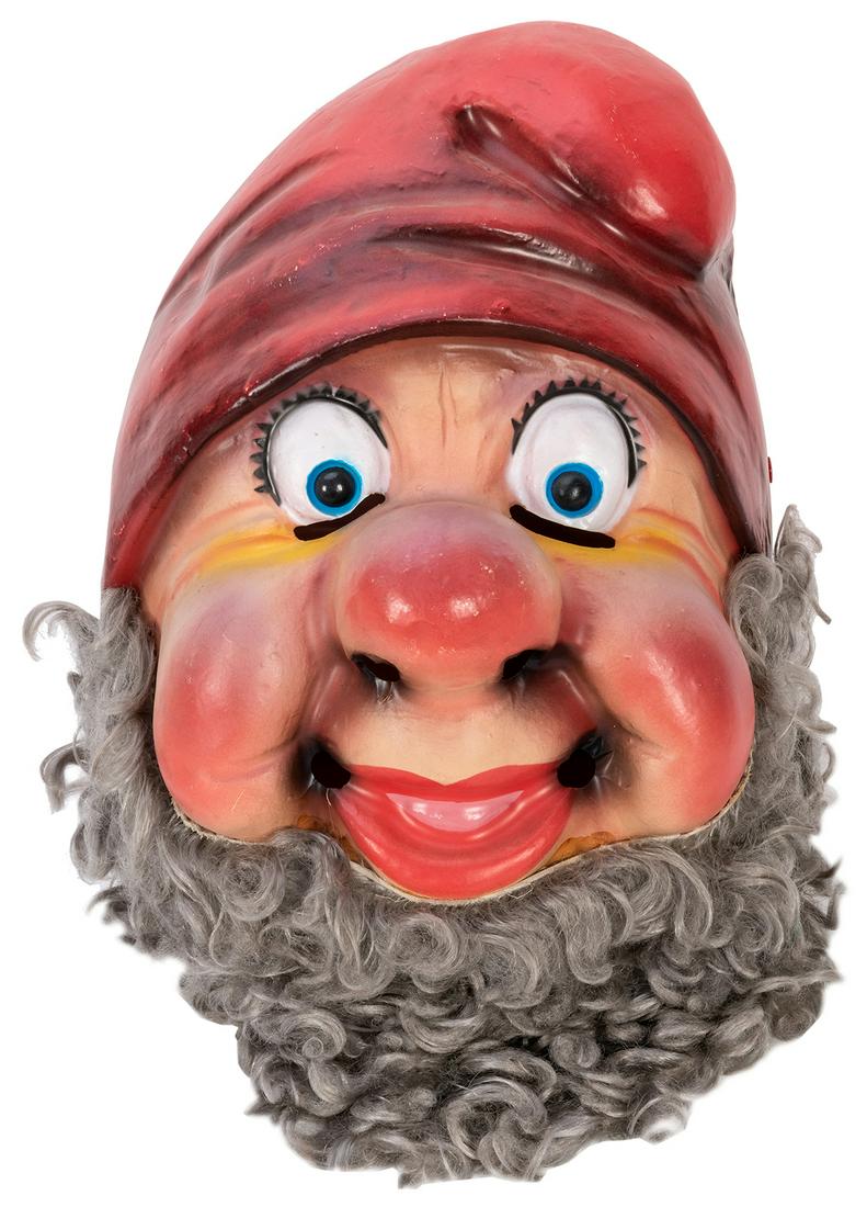 Dwarf Plastic Mascot Head. Circa 1950s. A molded: Dwarf Plastic Mascot Head. Circa 1950s. A molded celluloid head of a dwarf resembling Happy of Snow White and the Seven Dwarfs, with slits in eyes and mouth with attached gray beard. Approx. 17 x 10 x