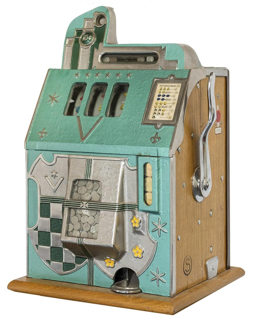 Mills 10 Cent “Coat of Arms” Slot Machine.: Mills 10 Cent “Coat of Arms” Slot Machine. Chicago, ca. 1931. 26 x 16 x 15”. Aquamarine front with “coat of arms” design which is a prototype or predecessor of Mills̵