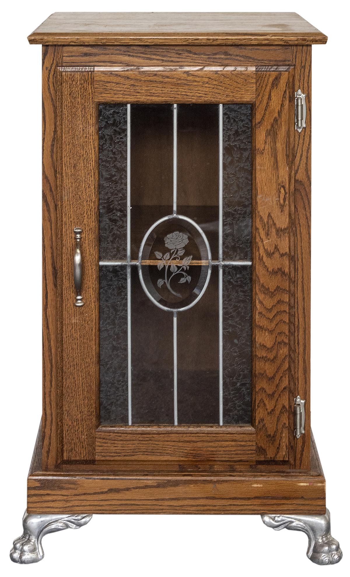 Slot Machine Stand. Oak slot machine stand with leaded: Slot Machine Stand. Oak slot machine stand with leaded glass front, central beveled glass frosted rose, claw feet, one shelf. Side drawer slides out for drinking glass or coin glass. 34 x 17 x 17̶