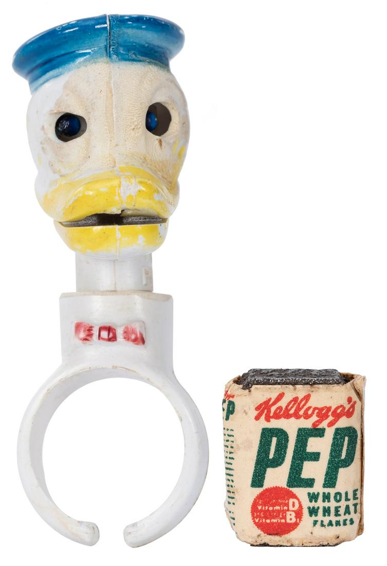 Kellogg’s PEP Cereal Donald Duck Living Toy Ring.: Kellogg’s PEP Cereal Donald Duck Living Toy Ring. Disney, 1950. A premium 2” tall ring named for its multiple movements that the cereal box magnet can induce to Donald’s head. With i