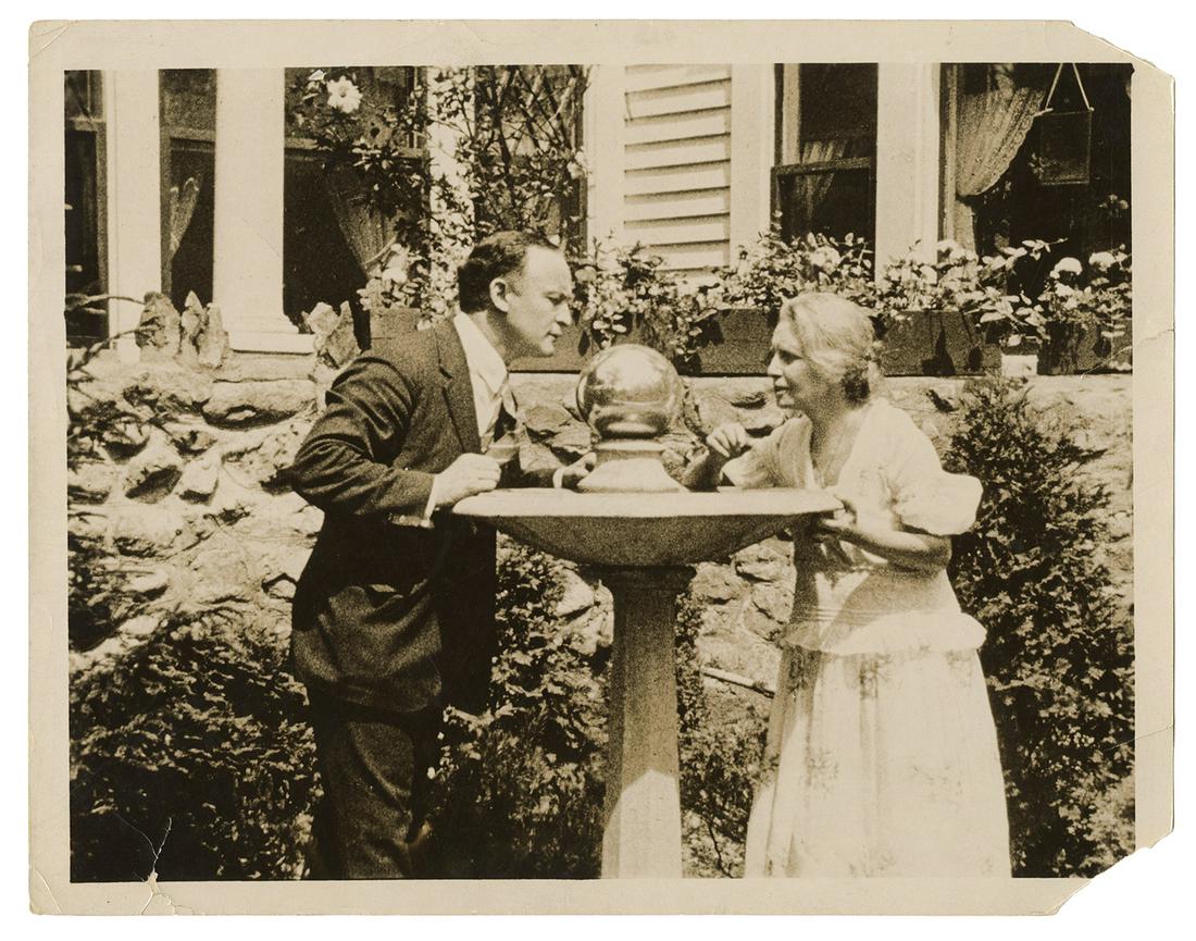 Houdini, Harry. Photograph of Houdini and Anna Eva Fay.: Houdini, Harry. Photograph of Houdini and Anna Eva Fay. [Massachusetts], 1924. Houdini and the famed theatrical medium stand outside her home in Melrose, Mass., gazing into a reflective sphere. 10 x 8