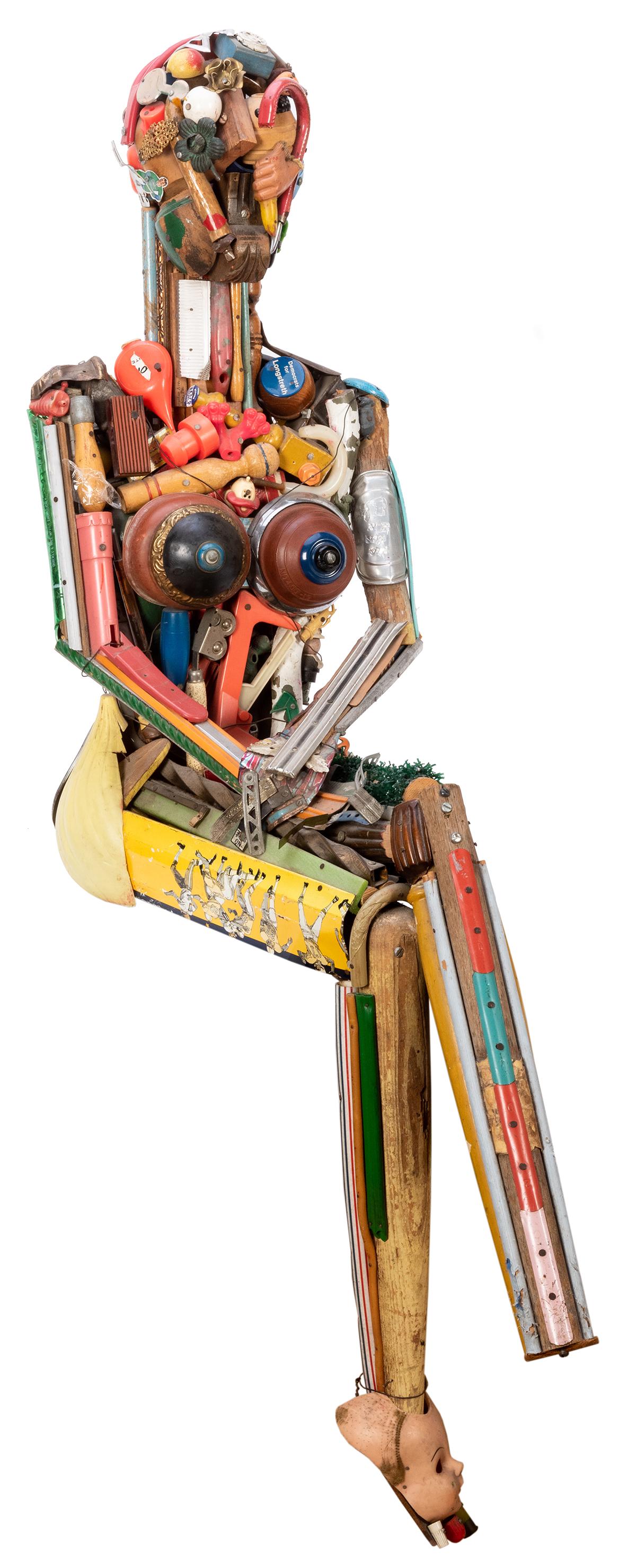 Sewell, Leo (b. 1945). Leo Sewell Seated Female Found: Sewell, Leo (b. 1945). Leo Sewell Seated Female Found Object Sculpture. 20th century. Sculpture of a female body composed of found plastic, wood, and metal scrap and pieces. Seated pose. Lacks one foo