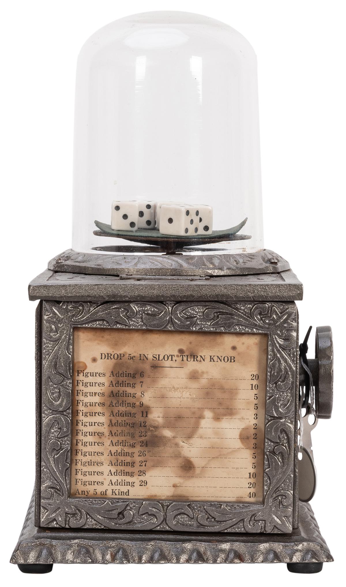 Cast Iron Dice Popper. Lincoln, NE, ca. 1920. Five-cent: Cast Iron Dice Popper. Lincoln, NE, ca. 1920. Five-cent coin operated gambling machine; insert the coin and crank the handle to roll the dice under the glass dome. The total on the dice determines the