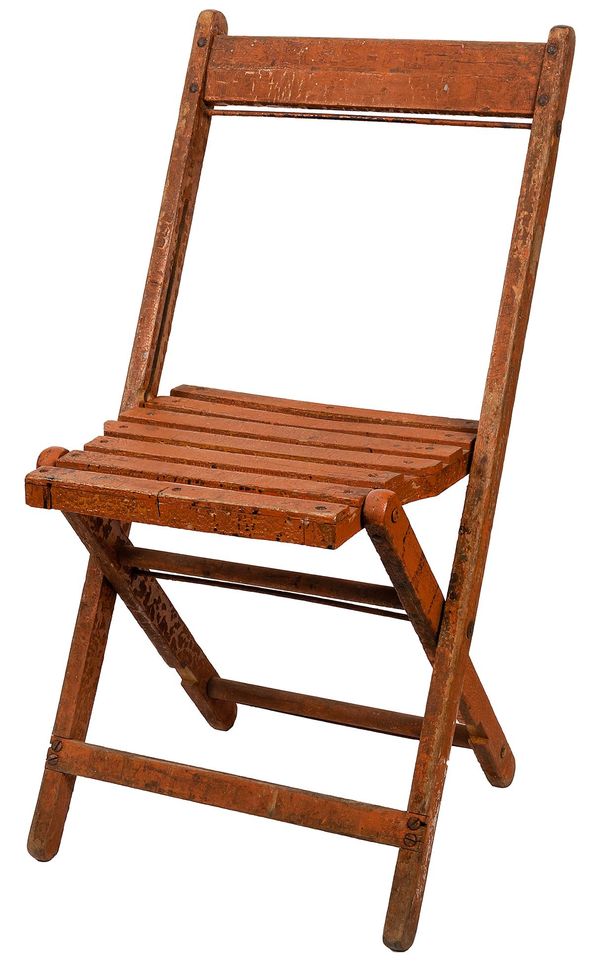 Sells—Floto Circus Folding Chair. American, ca. 1920s.: Sells—Floto Circus Folding Chair. American, ca. 1920s. Wooden folding chair with an old coat of orange paint, traces of “Sells—Floto” in stenciled lettering legible on the back