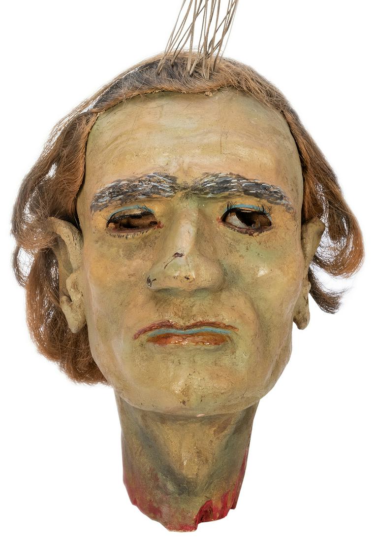 Decapitated “Salome” Head of John the Baptist: Decapitated “Salome” Head of John the Baptist Papier-Mache Prop. Circa 1950s. Expertly executed papier-mache male head with horse-hair wig, articulated eyelids, painted in greenish hues wi