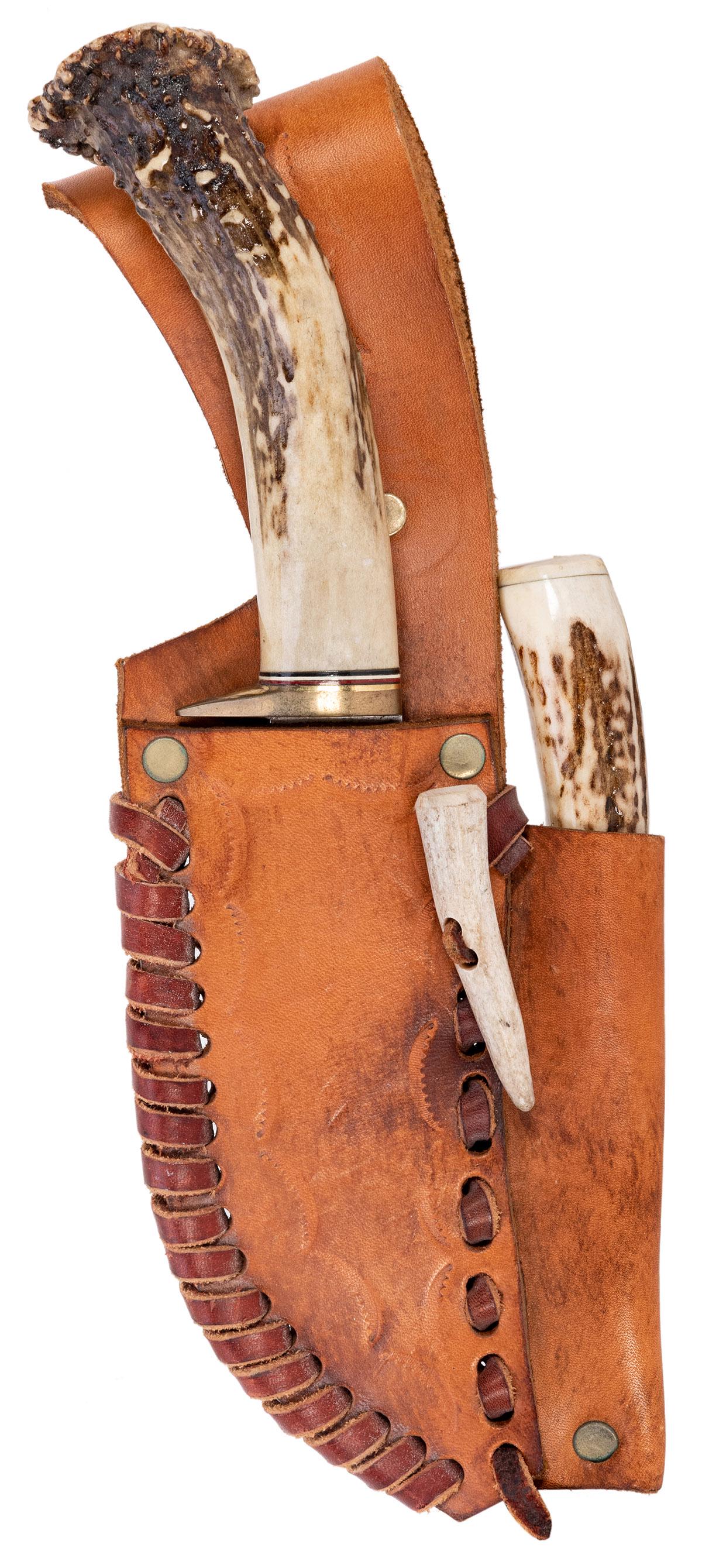Pair of Stag Knives in Leather Sheath. The longer knife: Pair of Stag Knives in Leather Sheath. The longer knife with a bear etched at the handle, 10 ¼”. Leather sheath 11 ¼”. Blades unmarked.