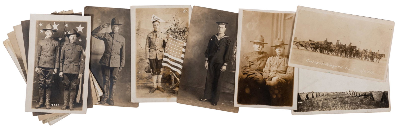 Group of 11 Portrait RPPCs of WWI Military Servicemen: Group of 11 Portrait RPPCs of WWI Military Servicemen and Encampments. Full-length portraits of soldiers in uniform, several with the American flag backdrop. Soiling and toning at edges, few with corn