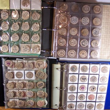 An accumulation of over 320 wooden nickels mounted - 2