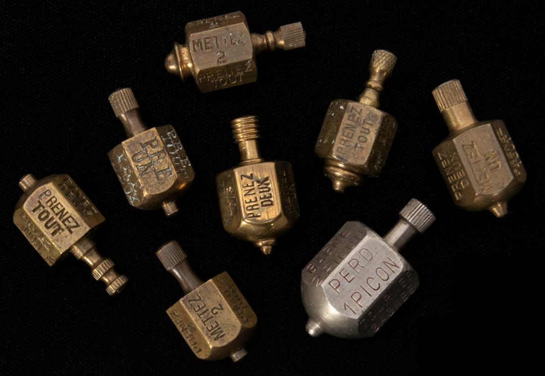 Lot of 8 French Put and Take Spinners. Seven brass and (1 of 1)