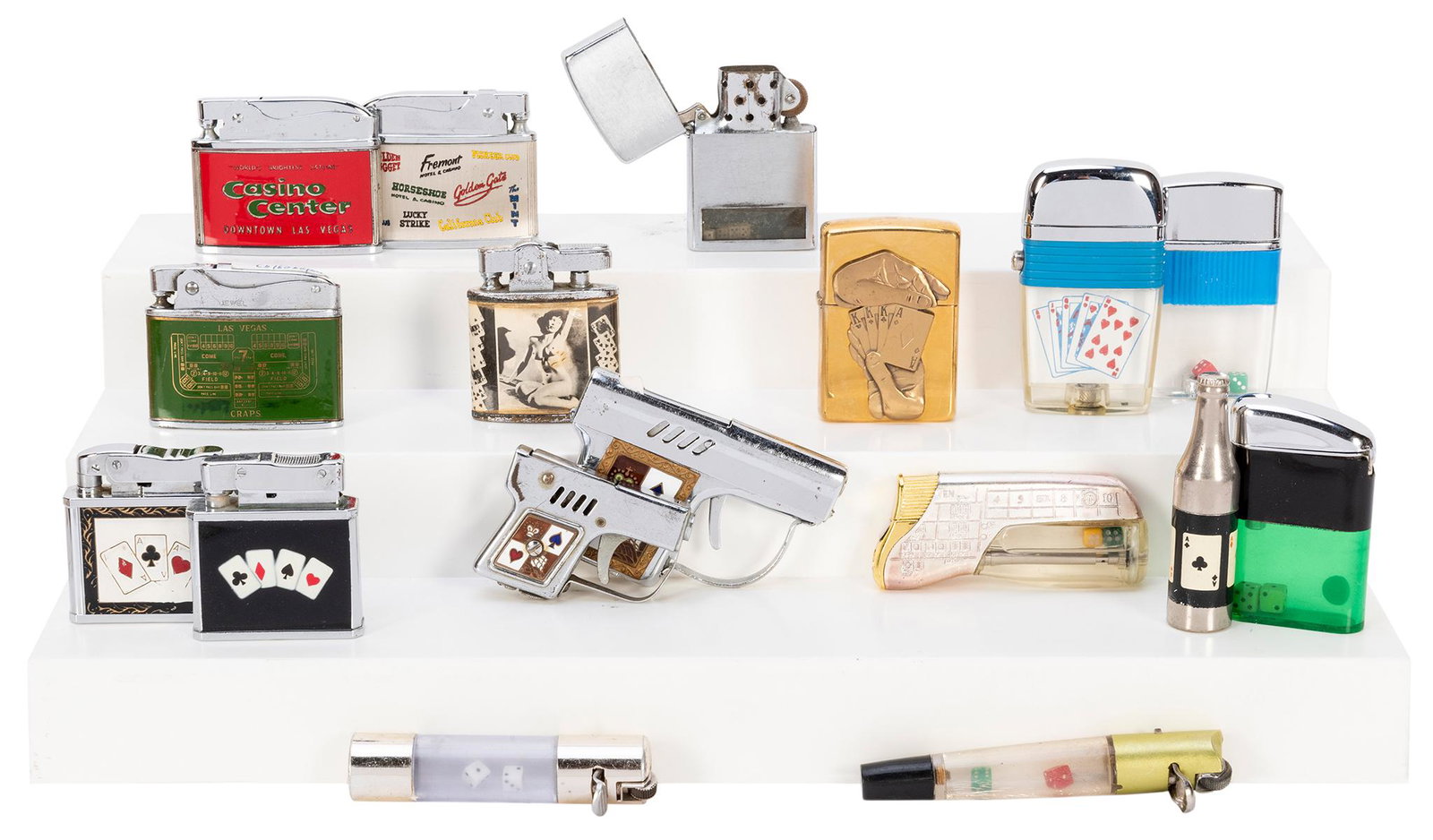 Group of 18 Gambling-Themed Lighters. Assorted vintage: Group of 18 Gambling-Themed Lighters. Assorted vintage lighters by Zippo, Jewel, Omega, Corona, Pinnacle, and others (many made in Japan), and featuring gambling and playing card imagery or miniature 