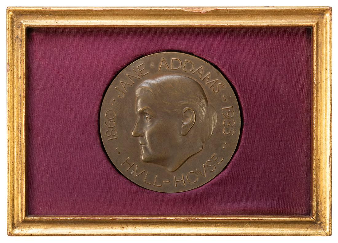 ADDAMS, Jane (1860–1935). Jane Addams Hull House 1935: ADDAMS, Jane (1860–1935). Jane Addams Hull House 1935 Bronze Medal. 75th anniversary bronze medal, set in a gilt frame with purple satin-lined backing. Frame size 5 x 7”. Medal diameter 3&