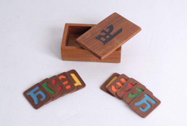 Enigmatic Trick by Alan Warner, ca. 1990. : Enigmatic. Cornwall, Alan Warner, ca. 1990. The magician and spectator each stack sets of charms in a wooden box, to later find that the charms were placed into the box in matching pairs, despite an u