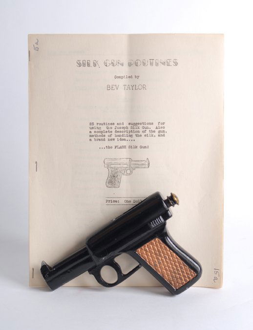Silk Gun by Chambers Manufacturing, ca. 1940.: Silk Gun. Clearwater Kansas, Chambers Manufacturing, ca. 1940. Mechanical cast metal faux-pistol automatically effects the vanish of a handkerchief draped over it when the trigger is pulled. Good cond
