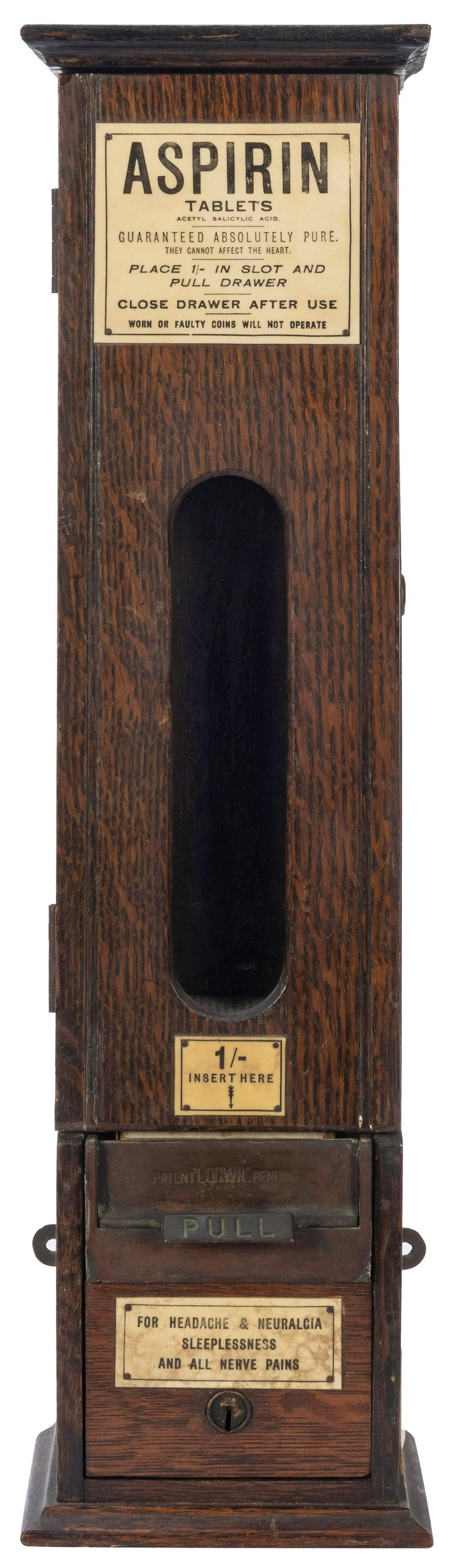 Antique Aspirin Wall Mount Coin-Operated Vending: Antique Aspirin Wall Mount Coin-Operated Vending Machine. Wood cabinet with vintage signage. Height 21”. Detached lock inside of vending chamber. Lock and key. Lock does not open. Not functionin