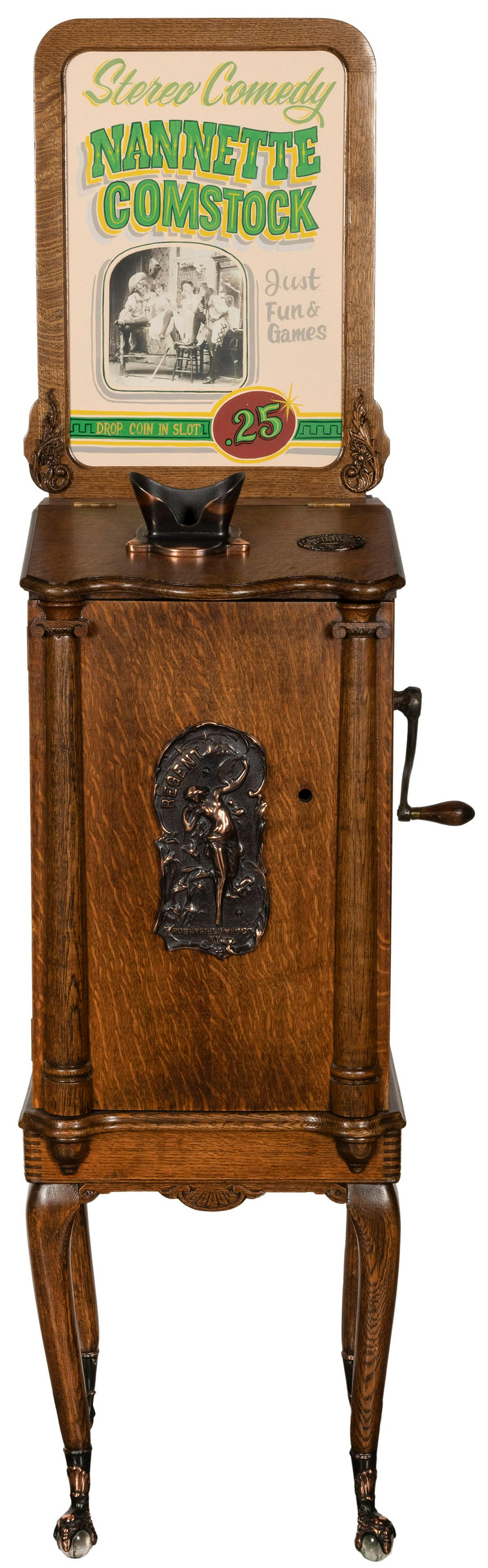 Rosenfield Mfg. Co. 1 Cent Regent Arcade Viewer: Rosenfield Mfg. Co. 1 Cent Regent Arcade Viewer Machine. New York, ca. 1900s. Beautifully restored arcade viewer, with oak cabinet, cast front plaque depicting a dancing woman, claw feet, and other ma