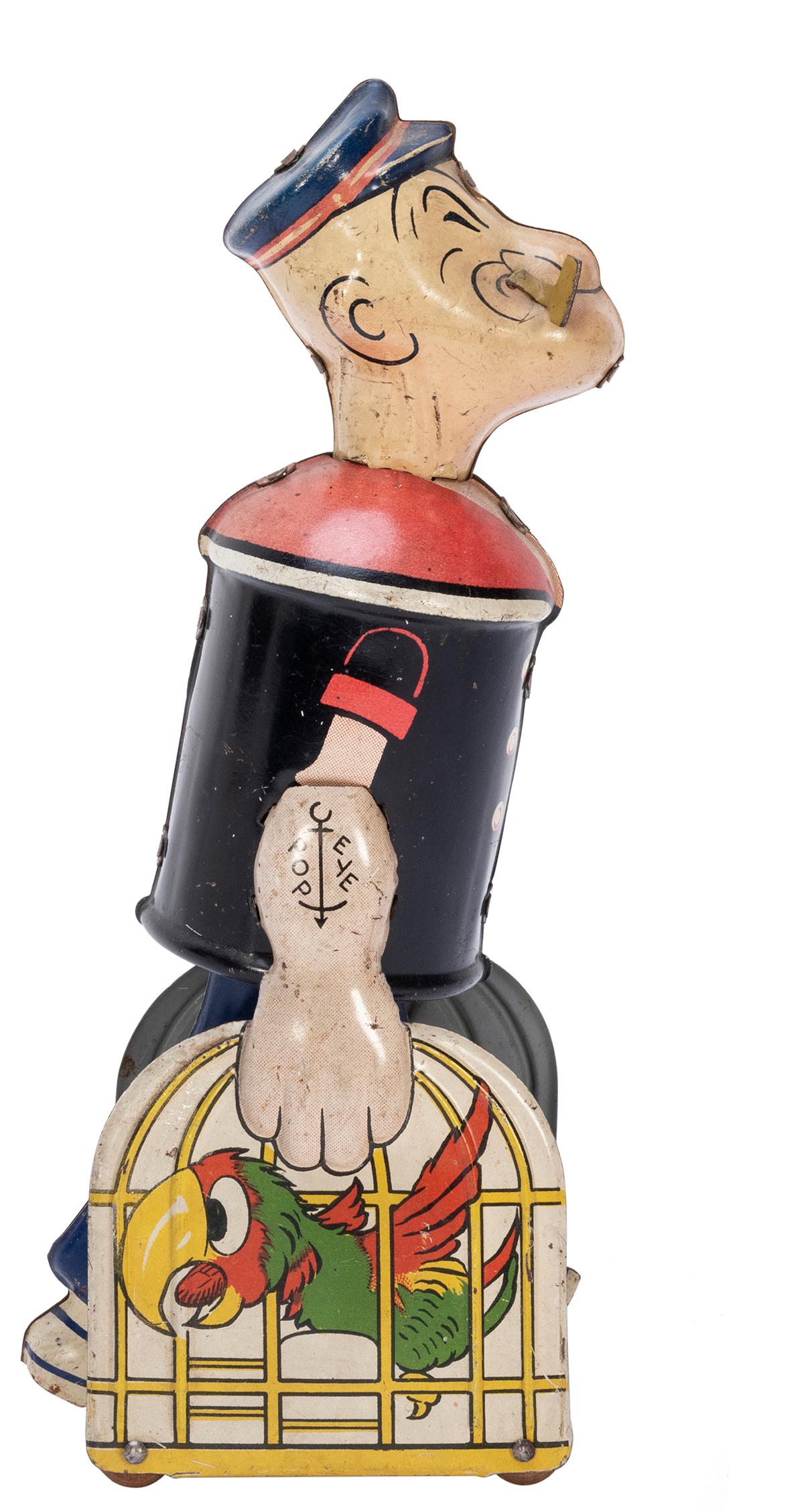 Marx Popeye Tin Litho Windup Toy. Popeye is seen: Marx Popeye Tin Litho Windup Toy. Popeye is seen carrying two parrot cages while smoking his pipe. Height 8”. With key, mechanism works. Some soiling with few small scratches.
