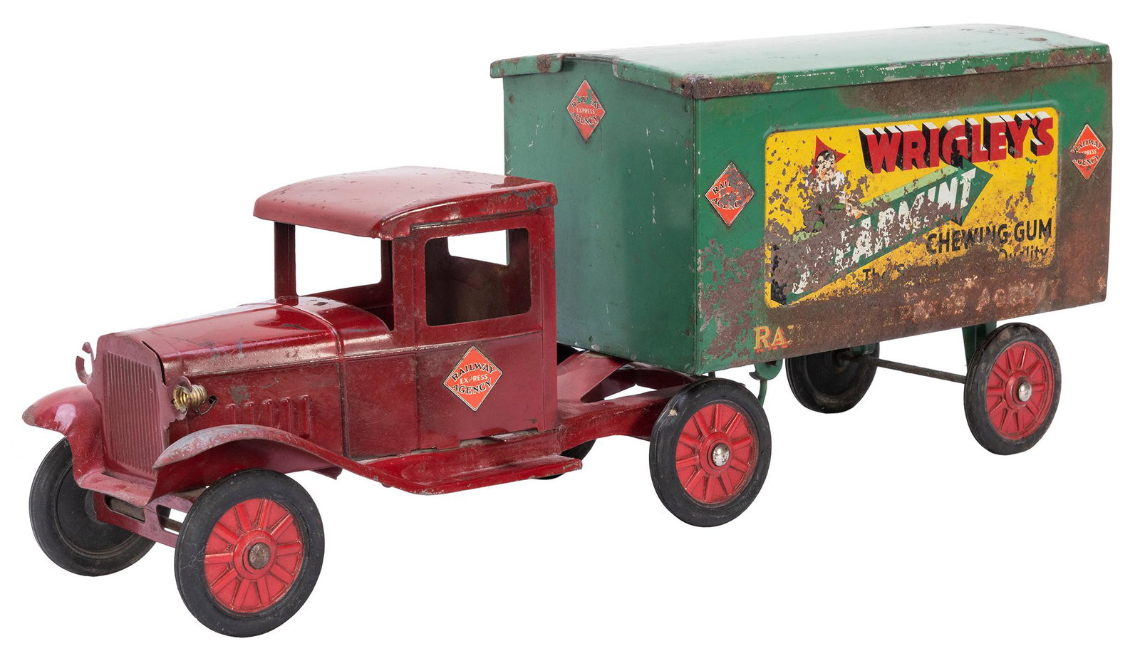 Buddy L Toy Co. Pressed Steel Wrigley’s Truck. Moline,: Buddy L Toy Co. Pressed Steel Wrigley’s Truck. Moline, IL, ca. 1930s. Length 23 ½”. One headlight missing. Rust on trailer affecting decals.