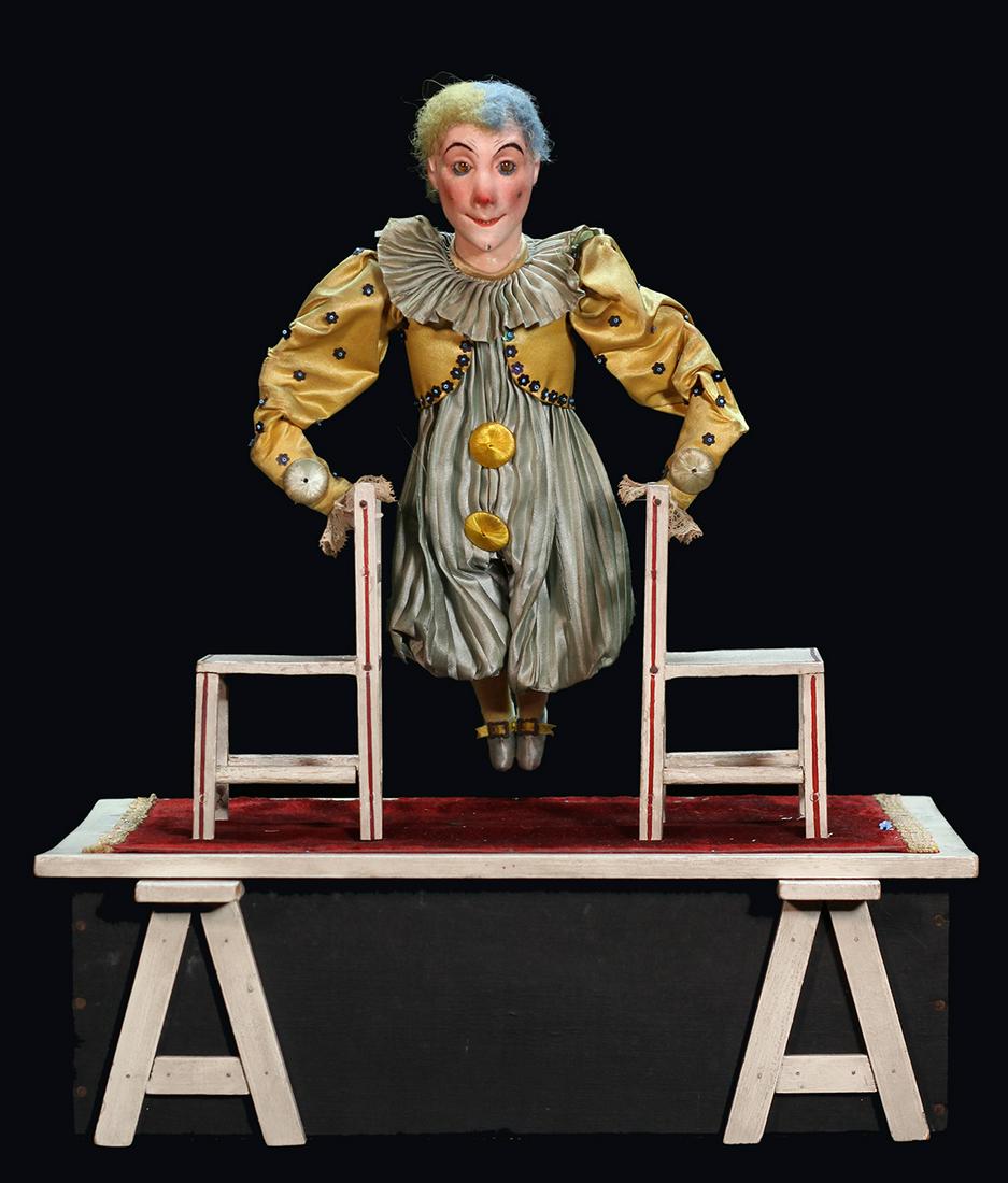 Renou Acrobat Clown Automaton on Two Chairs. Paris:: Renou Acrobat Clown Automaton on Two Chairs. Paris: Louis Renou, ca. 1910. A clown, his hands resting between two wooden chairs, slowly raises his body up, balancing on his hands, until the figure is 