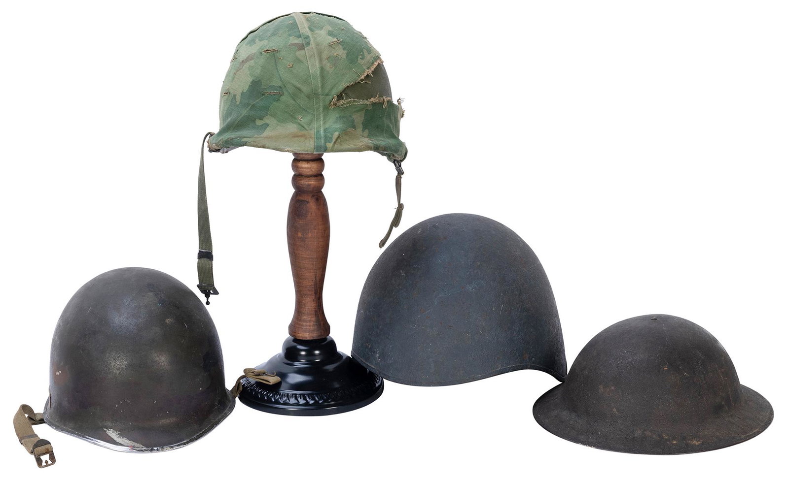 Lot of Four 20th Century American Military Helmets.: Lot of Four 20th Century American Military Helmets. Including: World War I Brodie helmet. Circa 1910s. Strap missing. – World War Two United States Navy MK-2 Talker helmet. Circa 1940s. Was desi