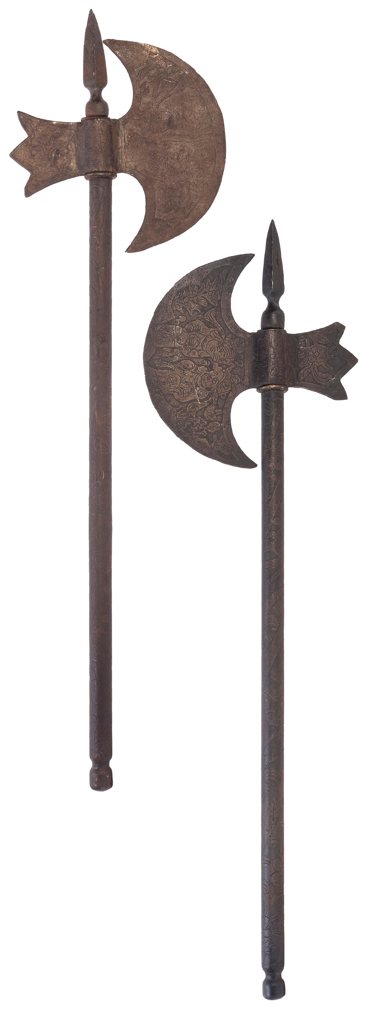 Pair of Indo-Persian Tabar Axes. Circa 19th century.: Pair of Indo-Persian Tabar Axes. Circa 19th century. Metal. Both axe blades depict two figures sitting amidst flowers. Floral motif is continued along both axe handles. Length 26 ½”. Rust, 