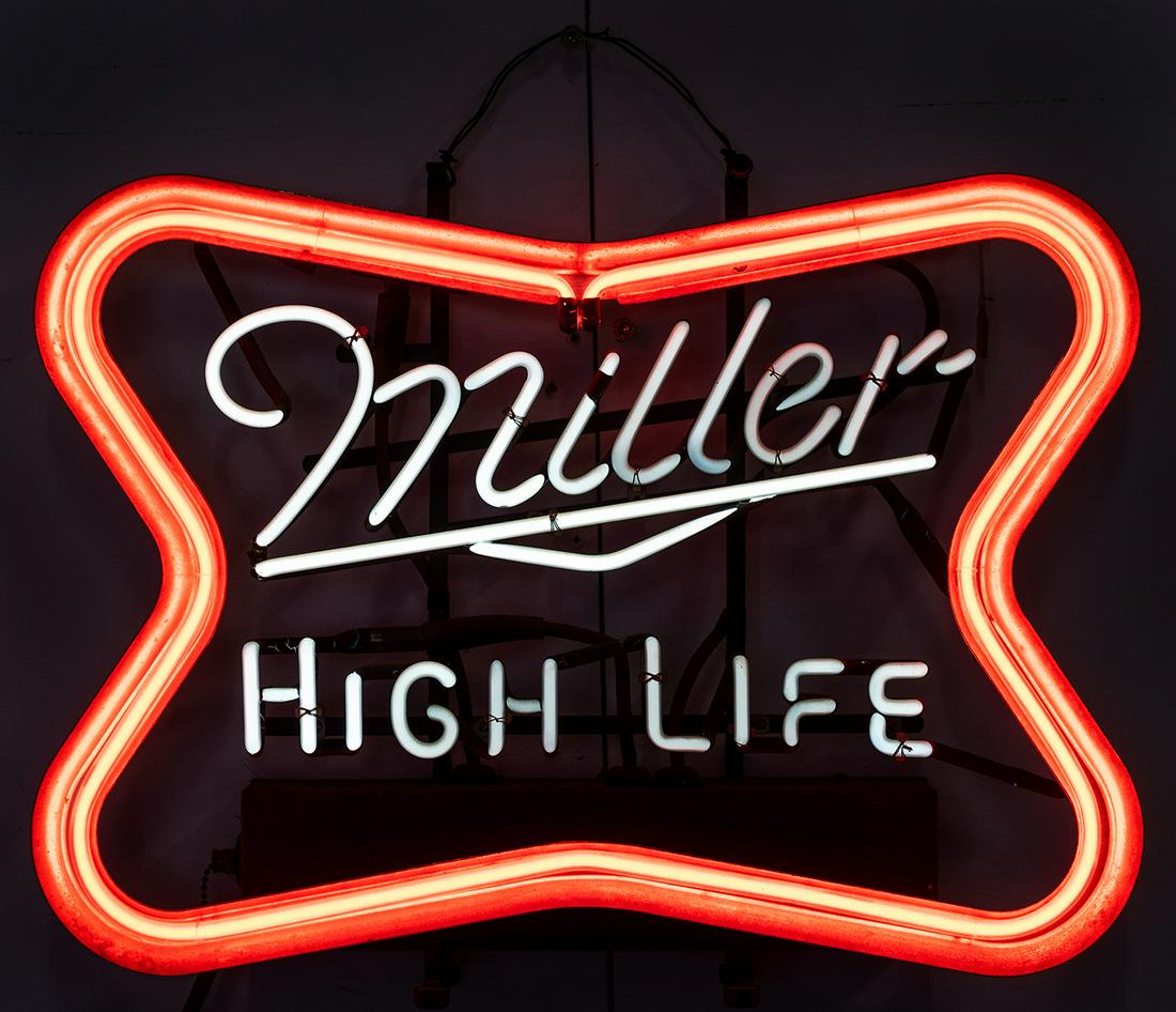Miller High Life Neon Beer Sign. 1970s. Famous bowtie: Miller High Life Neon Beer Sign. 1970s. Famous bowtie logo in bright neon, with blinking pattern. 16 x 21 ½”. Working. Third-party shipping required.