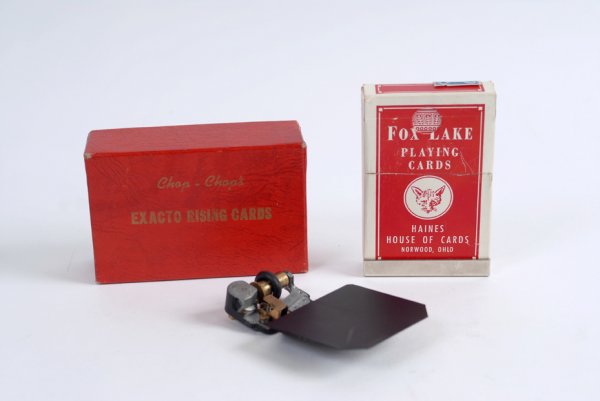 Exacto Rising Cards made by Al Wheatley, ca. 1960: Exacto Rising Cards. N.p., Al Wheatley, ca. 1960. Bench-made device allows the magician to cause selected cards to rise from the pack (which may be examined before or after the effect). Similar to Him