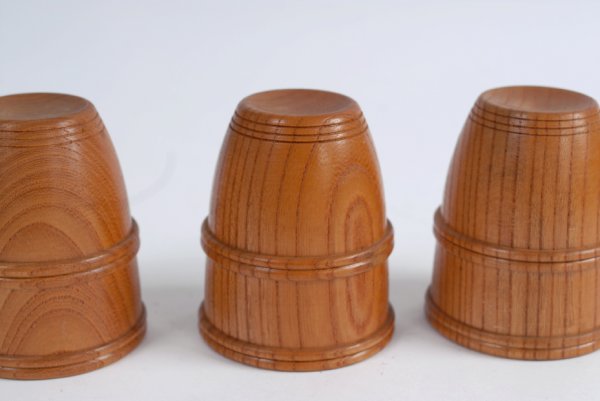 Cups and Balls owned by Dai Vernon. Mikame Craft, c: Cups and Balls owned by Dai Vernon. Mikame Craft, ca. 1985. Set of three lathe-turned oak cups with a double bead pattern, and three balls (fourth lacking) covered with a green sparkle-pattern fabric.