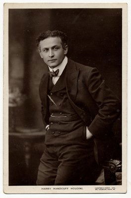 Real photo postcard, ¾ length portrait of Houdini.: Houdini, Harry. Real photo postcard bearing a ¾ length portrait of Houdini. London, ca. 1916. Divided back; postally unused. Good condition. From the collection of Dai Vernon.