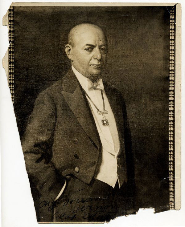 Photograph of Max Malini inscribed to Dai Vernon: Malini, Max (Max Katz Breit). Sepia-toned ¾ length photograph of Malini, signed and inscribed. N.p., ca. 1925. This photo depicts a painting of Malini wearing white tie and tails. 8 x 10". Significan