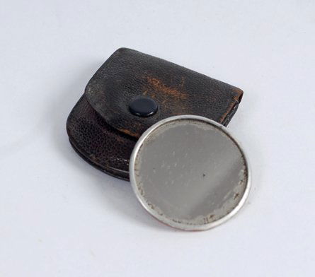 Gambler's Shiner owned by Dai Vernon.: Gambler's Shiner owned by Dai Vernon. A small round mirror, approximately the size of a US silver dollar, used to secretly glimpse the identity of playing cards. Encased in a flesh-colored metal backi