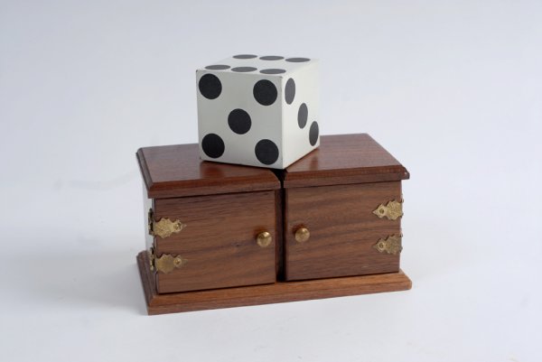 Die Box. Cashmere, House of Babcock, ca. 1989: Die Box. Cashmere, House of Babcock, ca. 1989. Handsome hardwood box and 2 ¾" die for the traditional "sucker" effect. With double door feature. Housed in a denim carrying bag. Light wear from use, b