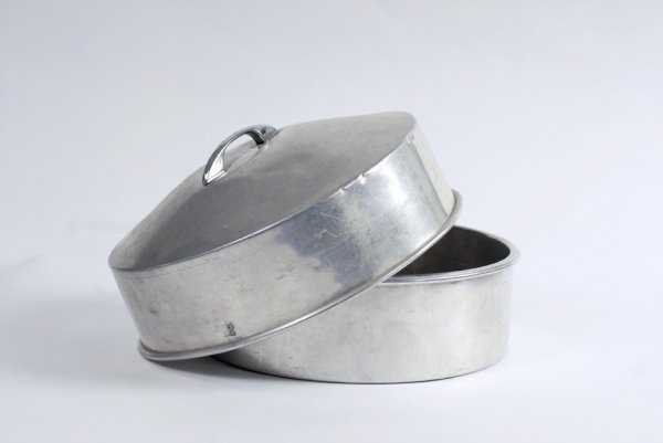 Duck Pan. New Haven, Petrie and Lewis, ca. 1950: Duck Pan. New Haven, Petrie and Lewis, ca. 1950. Large aluminum pan and lid from which a massive quantity of articles, or even a live duck, can be produced. 11 " in diameter. Hallmarked. Worn from use