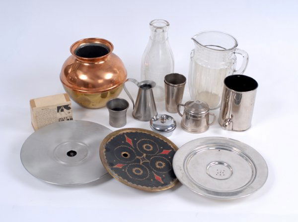 Group of ten vintage magic tricks with liquids: [Liquid Tricks] Group of ten vintage magic tricks with liquids. Including three trays for the vanish of liquid from a bottomless cup, a Jumbo Lota Bowl (Sherms, dented), DeMuth Milk Bottle (in need of