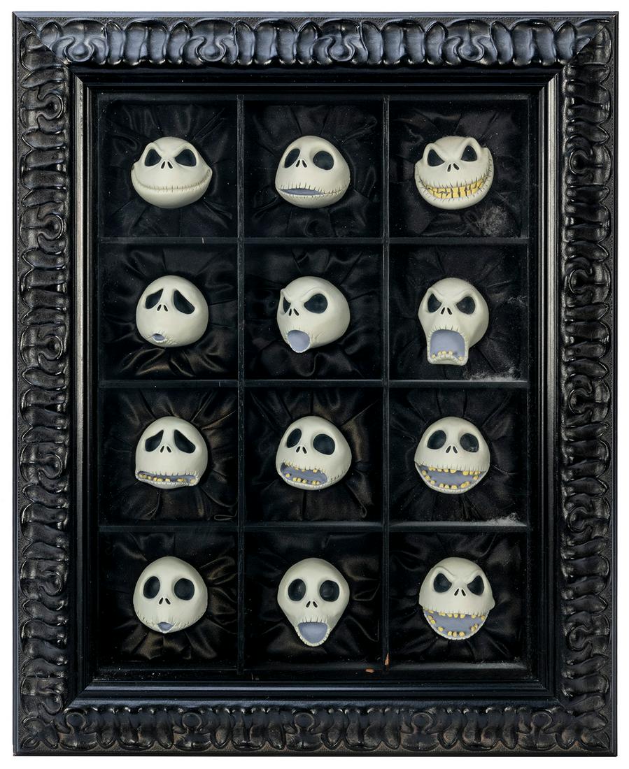 The Nightmare Before Christmas 12 Faces of Jack: The Nightmare Before Christmas 12 Faces of Jack Skellington. Circa 1990s. Twelve Jack Skellington heads set in an ornate black shadow box. 16 ½ x 13 x 3 ½”. Signed by Tim Burton. Limit