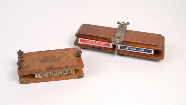 Two Wooden Card Presses ca. 1940s: Two Wooden Card Presses. One a two-deck press manufactured by Watts of Sheffield, England, the other a single-deck press from an unknown maker and bearing a stamped playing card design. Ca. 1940s. Bot