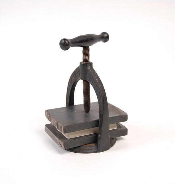Cast iron playing card press. Newark, Osborne & Co.: Cast iron card press. Newark, Osborne & Co. Cast iron press likely repurposed for pressing decks of cards. Good condition.