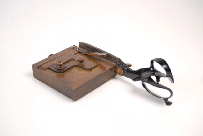 Shear-type Playing Card Trimmer. American.: Shear-type Card Trimmer. American. Brass platen shear-type trimmer for cutting down (squarely or otherwise) playing cards. Finger guard/clamp incorporated into the design. Platen measures 6 x 6". Stam