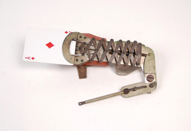 Lazy Tong/Jacobs Ladder-style Holdout. Maker unknow: Lazy Tong/Jacobs Ladder-style Holdout. Maker unknown, ca. 1925. Lazy-tong style brass holdout with large leather and metal arm straps. Leather replaced and lacking the activation linkage, but still a 