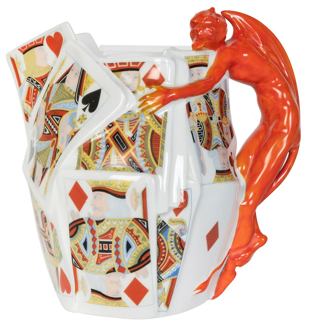 Royal Bayreuth Devil and Cards Pitcher. Tettau,: Royal Bayreuth Devil and Cards Pitcher. Tettau, Bavaria: Royal Bayreuth, ca. 1930s. A smiling devil cradles a group of playing cards arranged to form a pitcher. 7 ½ x 7 ½”. Blue mark. 