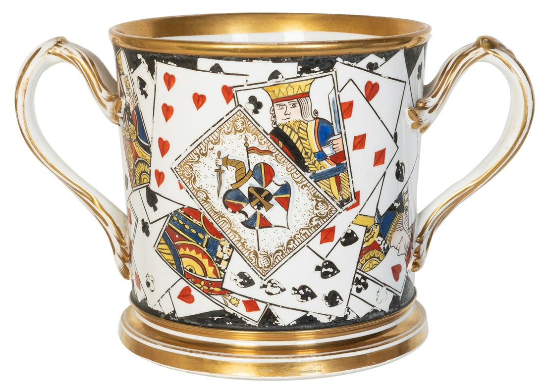 Porcelain Playing Cards Loving Cup. [English], ca.: Porcelain Playing Cards Loving Cup. [English], ca. 1860s. Fine porcelain two-handled loving cup with playing cards painted around side, including coat of arms on the Ace of Spades. With gilt accents. 